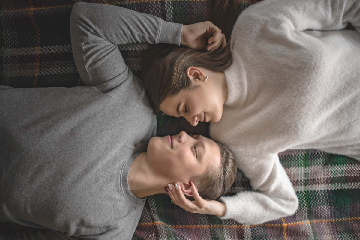 Couple lying on bed | How Regular Sex Can Strengthen a Relationship