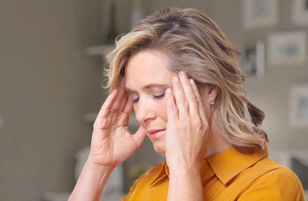 Woman having headache migraine | Symptoms of Menopause And How To Treat Them