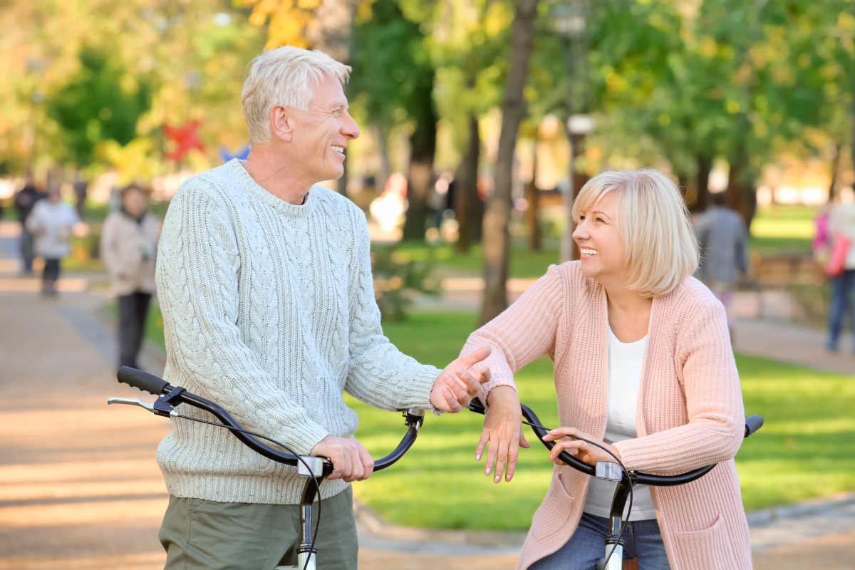 Cute elderly couple with bicycles in autumn park | More Sex Can Prevent Heart Attacks, According To Science