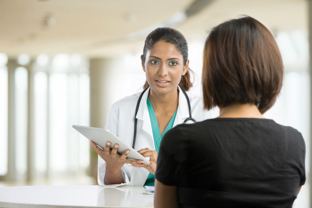 Indian doctor talking with female patient in doctors office | Is Your Vagina Depressed? Symptoms of Vulvodynia and How To Treat It