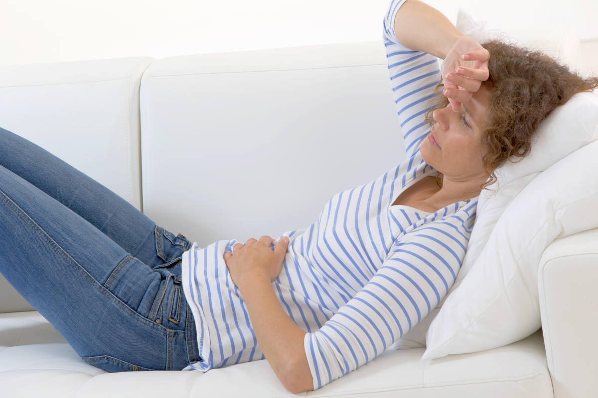 Middle aged woman stroking her belly because of bellyache | Everything You Should Know About Vaginal Dryness During Sex