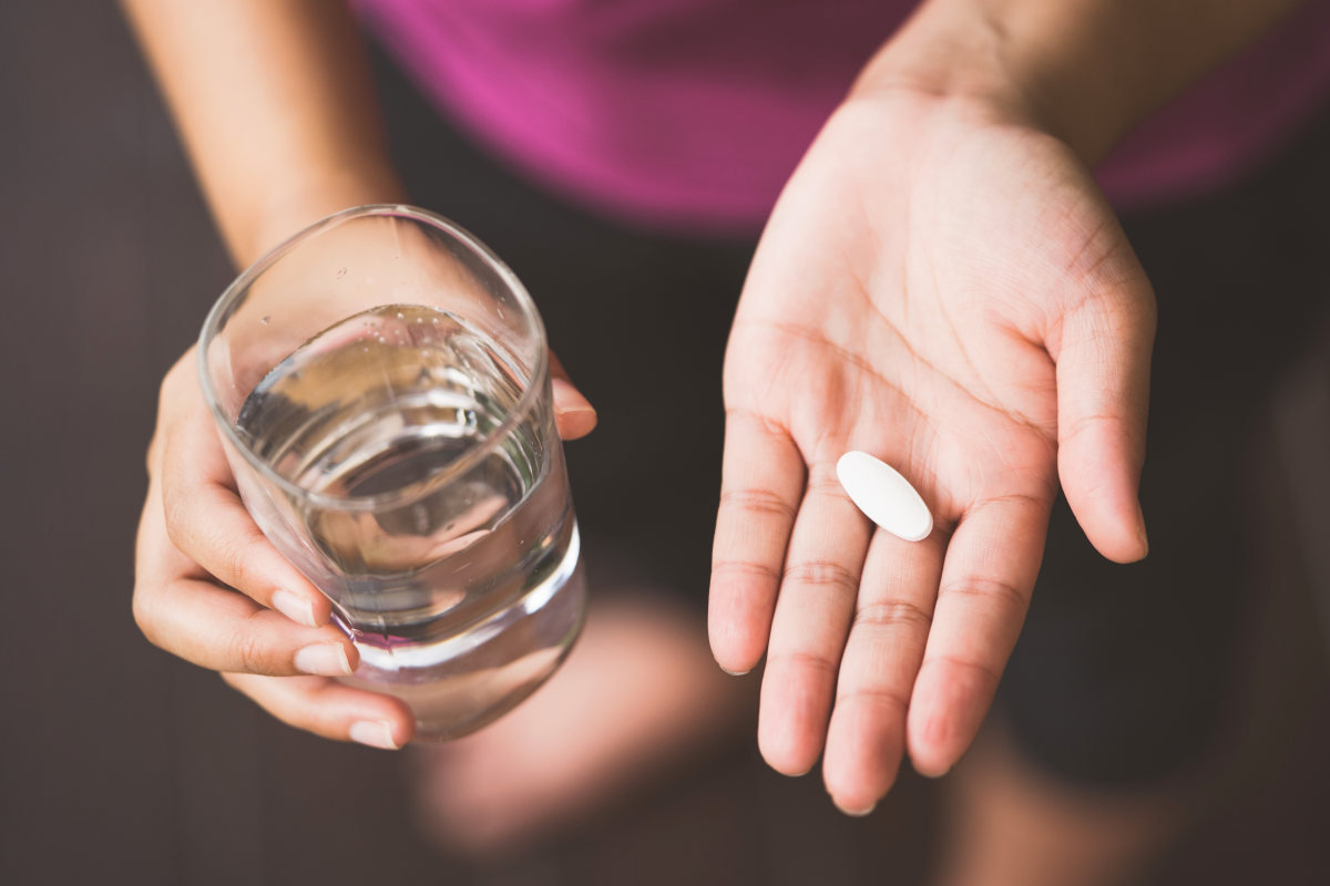 Girl holding Pill and glass of water | Home Remedies For Vaginal Dryness | Vaginal Dryness Home Remedies