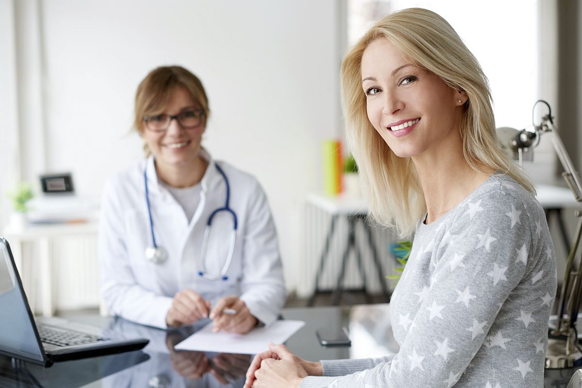 Shot of a beautiful mature woman sitting in doctor's office | HRT Hormone Replacement Therapy Frequently Asked Questions