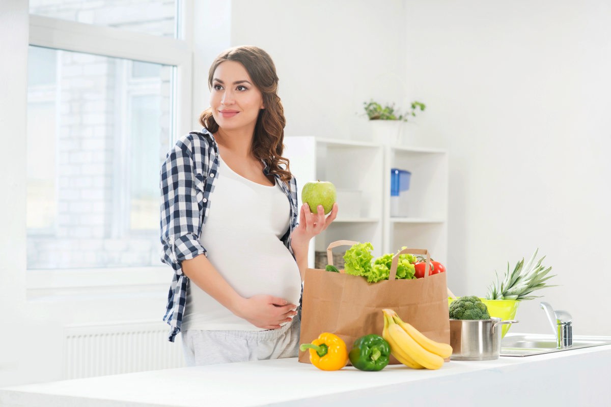 Beautiful pregnant woman in the kitchen | What Foods Are High in Estrogen? | soy isoflavones