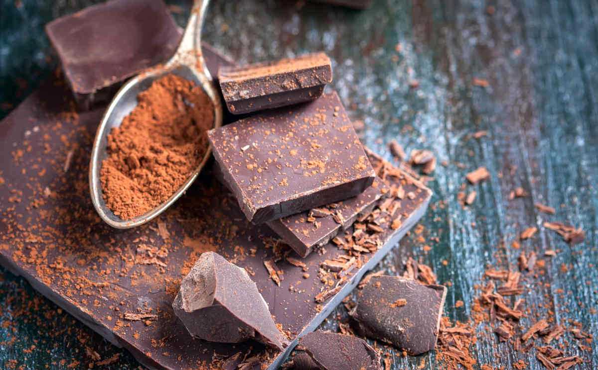 Dark chocolate over wooden background, selective focus | What Foods Make Menopause Worse? | foods for menopause