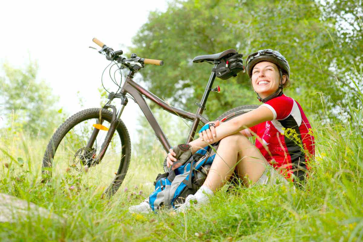 Happy Young Woman riding bicycle outside | What Are The Symptoms of Hormonal Imbalance? | hormone therapy