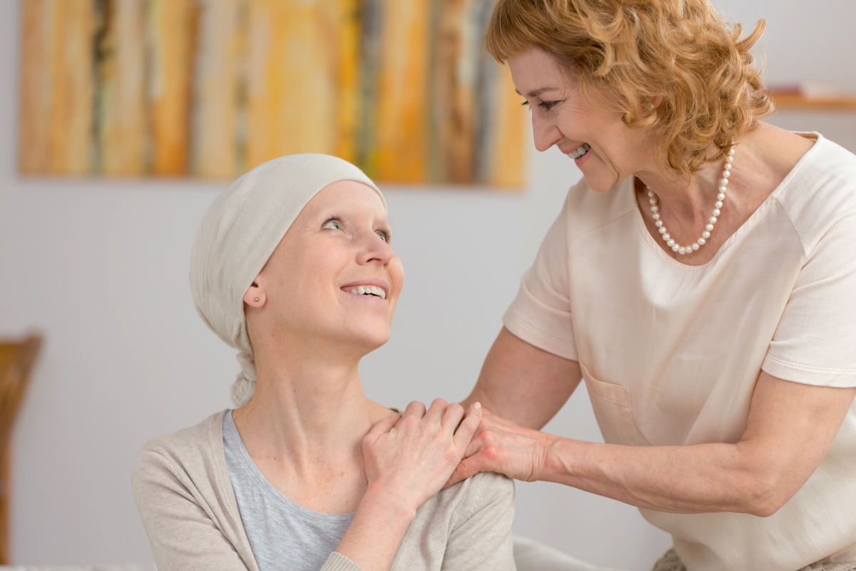 Senior woman holding her suffering from cancer friend's arm | What Happens When Estrogen Levels Are High? | High Estrogen | effects of high estrogen