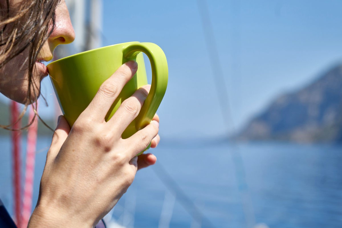 Woman drinking coffee in green glass | What Foods Make Menopause Worse? | Hormone levels
