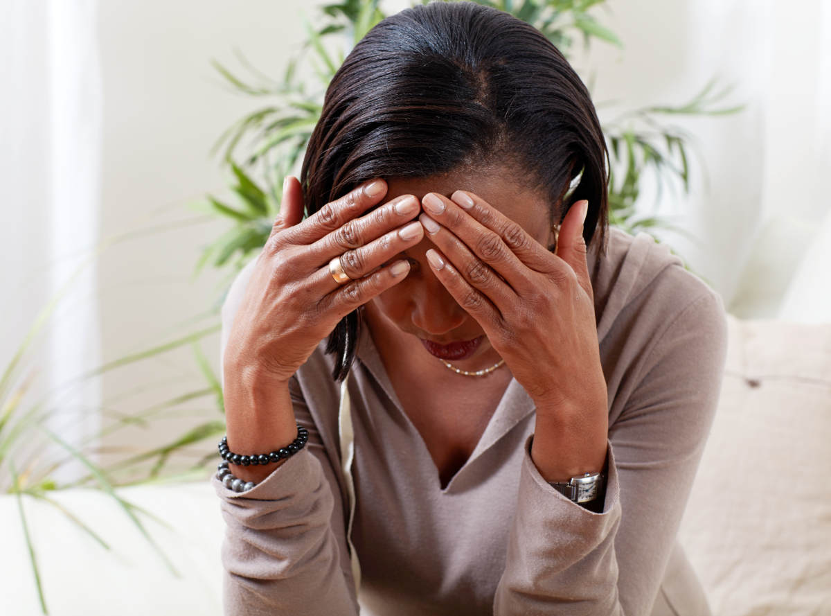 Woman experiencing migraine | What Is Estrogen Dominance And What To Do About It? | estrogen imbalance