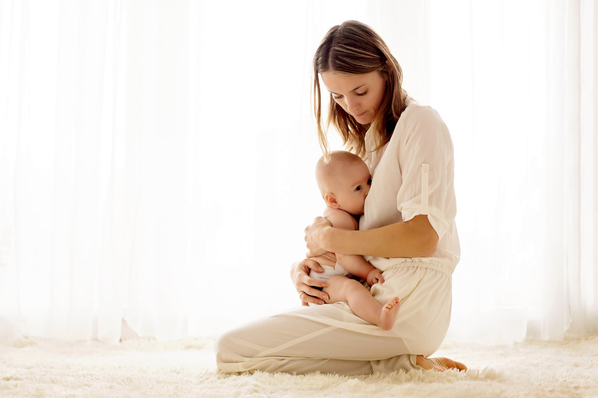 Young mother breastfeeding her newborn baby boy at home | The Estrogen Family: Estrone, Estradiol, Estriol | where is estrogen produced