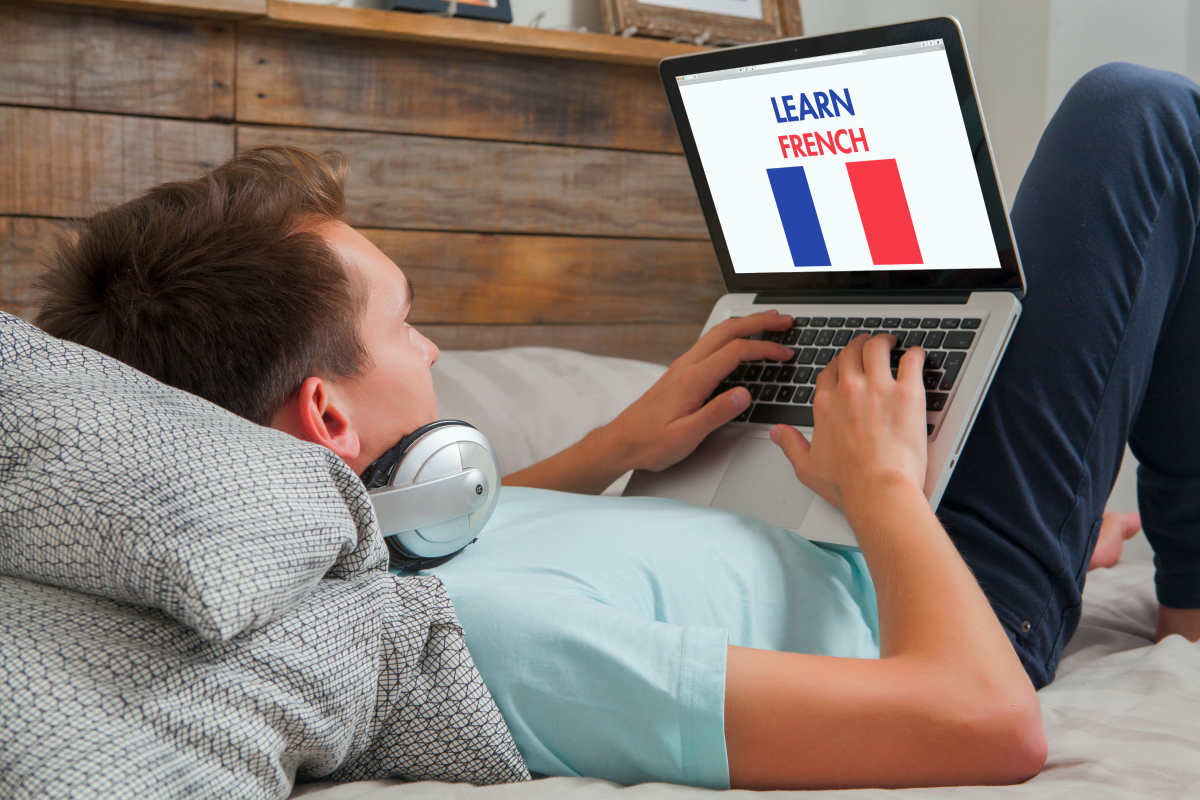 Man learning french on the internet with a laptop computer | The Ultimate List Of Brain Boosters: Ways To Increase Your Brain Power | boost brain power
