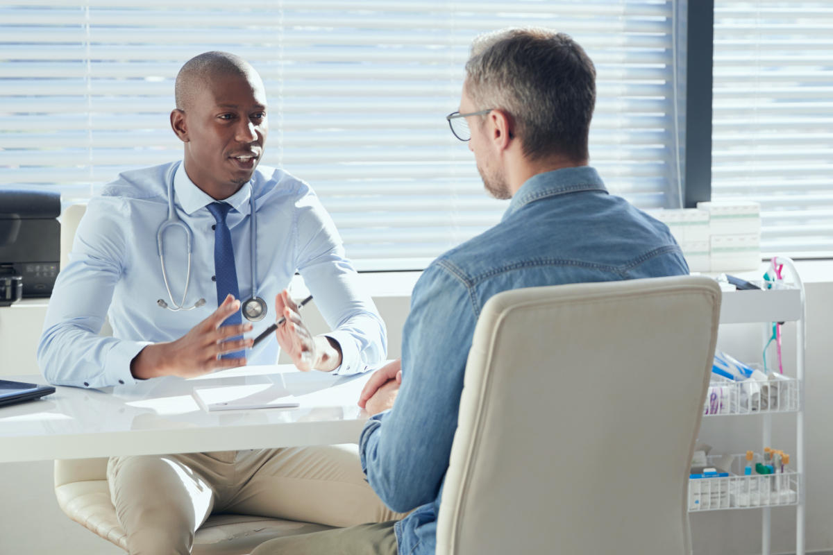 Mature Male Patient In Consultation With Doctor In Office | TRT Done Right - Why More Men Are Opting For This Testosterone Replacement Protocol | testosterone in men