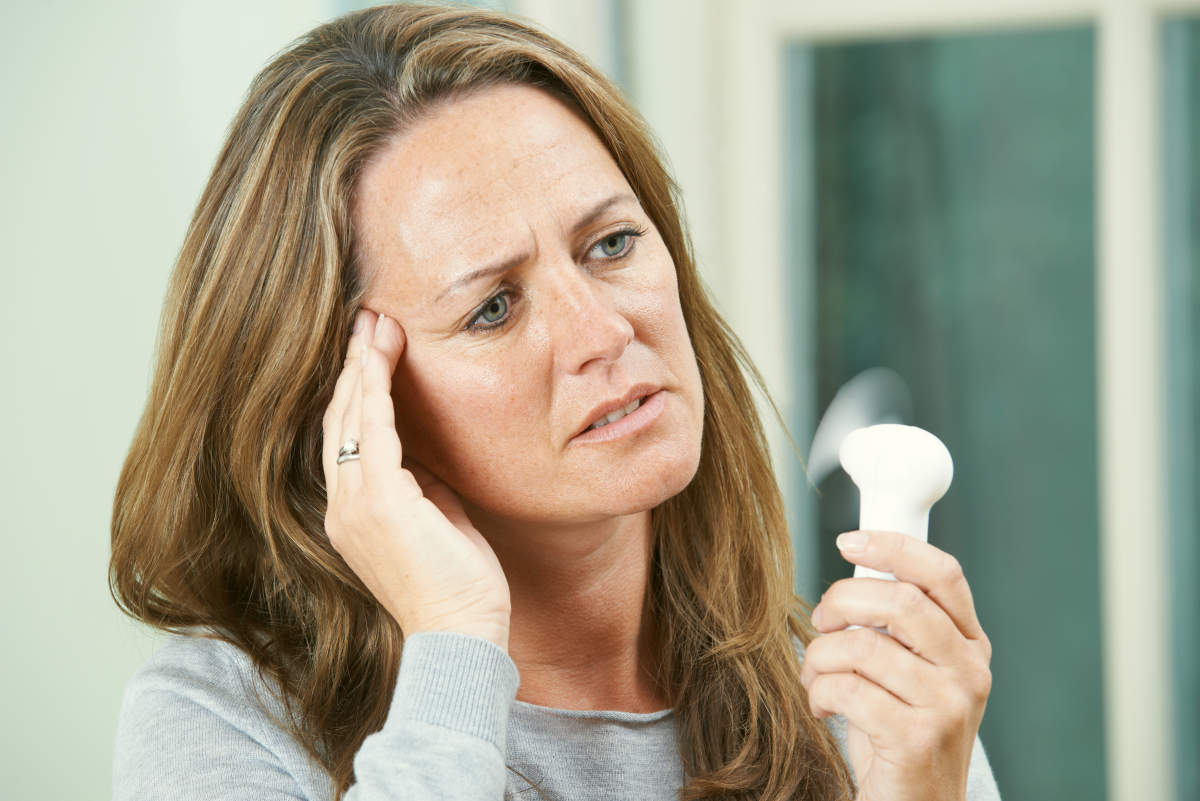 Mature Woman Experiencing Hot Flush From Menopause | No Sex: Causes of Low Sex Drive In Women | low libido treatment