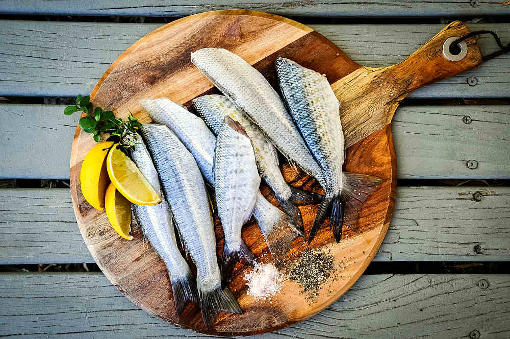 Fish on wooden background | Diet For Hypothyroidism: Food To Include In Your Diet Plan | thyroid diet for weight loss