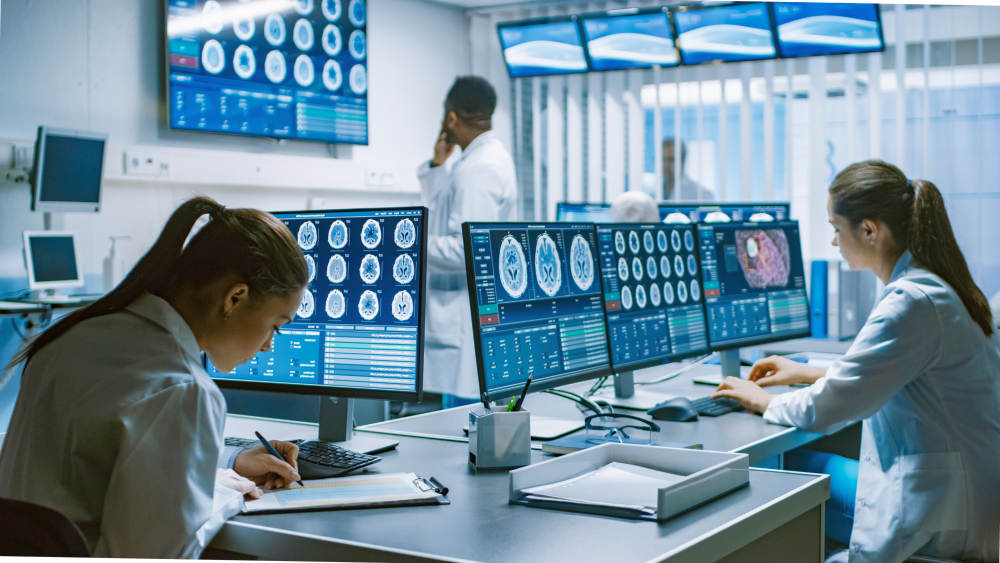 Neuroscientists Surrounded by Monitors Showing MRI Scans | Anti Aging Myths Debunked