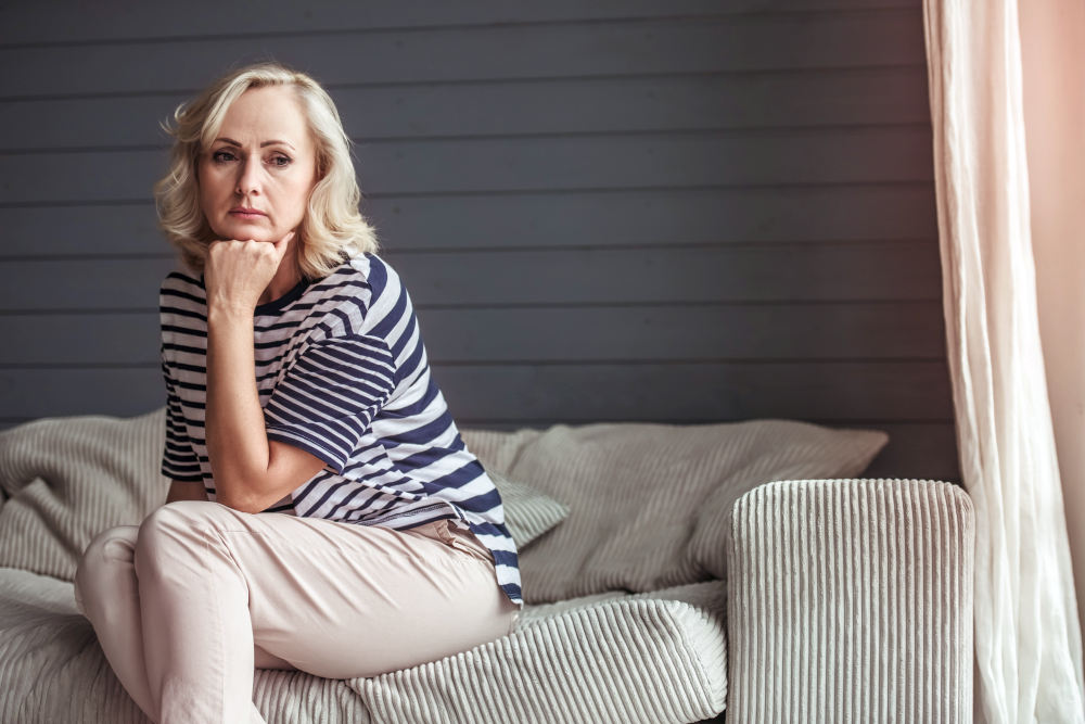 Beautiful sad senior woman is leaning on her hand and looking away | Aging Process In A Woman's Body | female body changes at 40