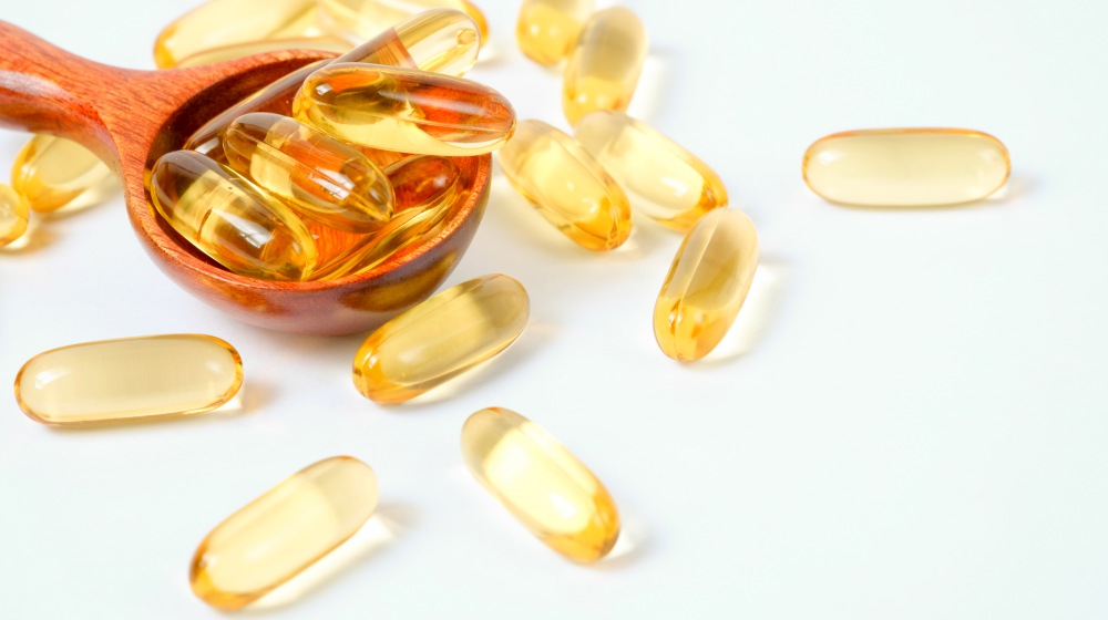 fish oil capsules on wooden spoon | Hypothyroidism Treatment | Natural Remedies For Thyroid Health | hypothyroidism treatment | hypothyroidism diet