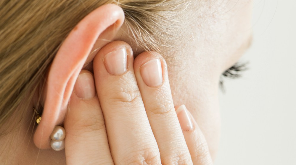 woman holding her ear | How Ear Sensitivity Is Affected By Hypothyroidism | ear sensitivity | ear sensitivity and hearing