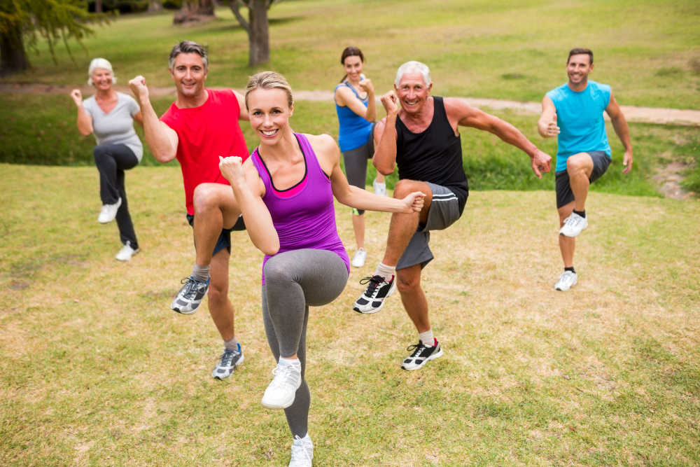Happy athletic group training on a sunny day | Aging Gracefully Strategies Anyone Can Do Today | how to keep your skin young