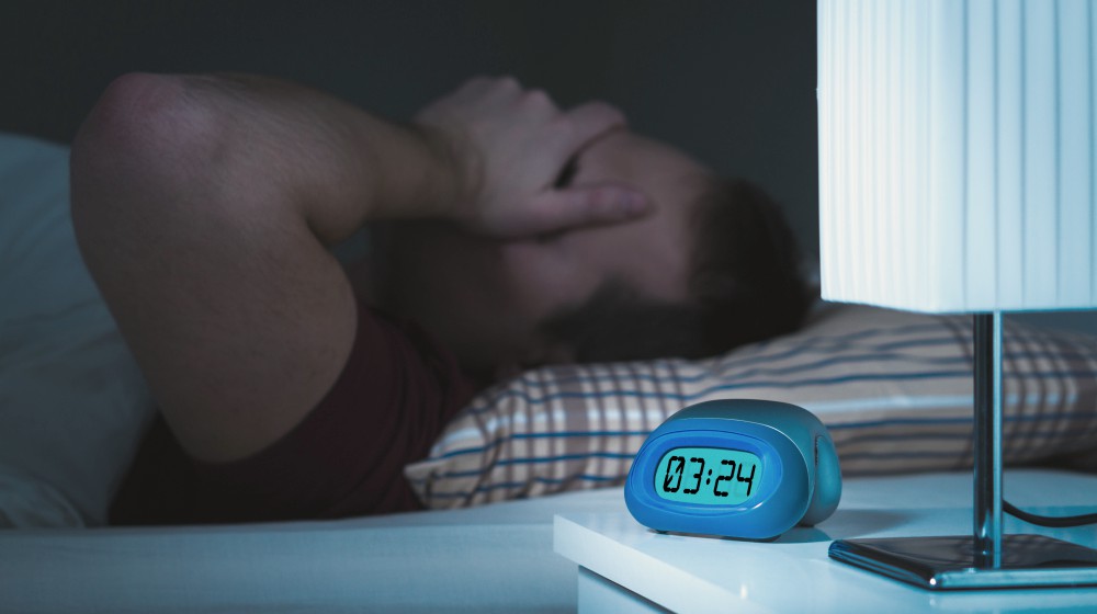 man having trouble sleeping | How Lack Of Sleep Affects Metabolism And Causes Weight Gain | sleep and metabolism | lack of sleep cause
