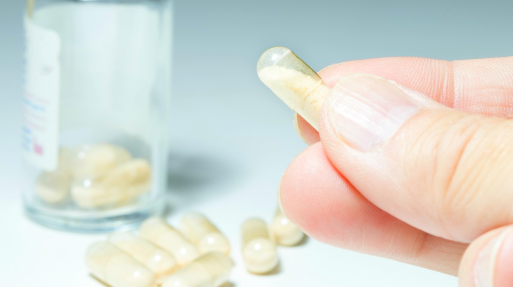 man takes probiotic transparent capsule | Hypothyroidism Treatment | Natural Remedies For Thyroid Health | hypothyroidism treatment | hypothyroidism diet plan