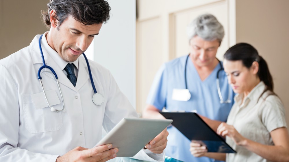 male doctor holding digital tablet | What Is The Difference Between Telehealth And Telemedicine? | telehealth vs telemedicine | telemedicine or telehealth