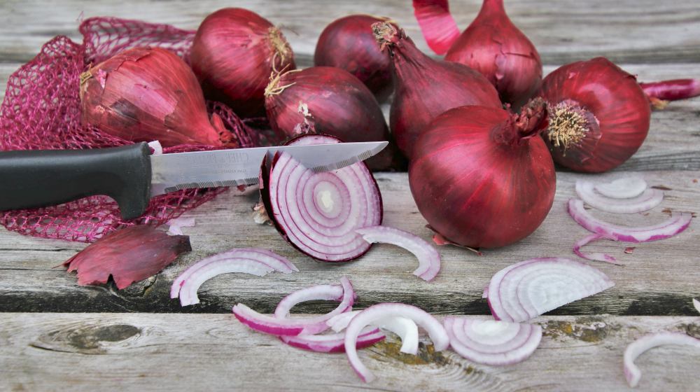 sliced red onions on table | Amazing Benefits Of Red Onions For Your Thyroid Glands | red onions | natural compounds in red onions