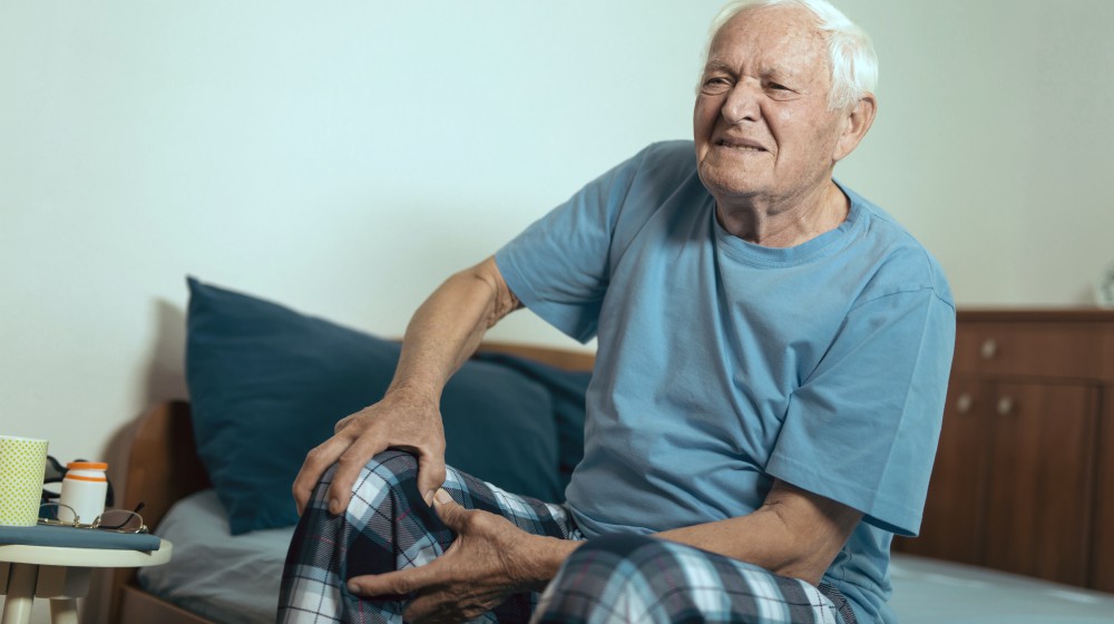 senior man feeling pain on his knee | Senescent Cells Linked To Osteoarthritis; How Clearing Them Can Help | osteoarthritis | senescent cells