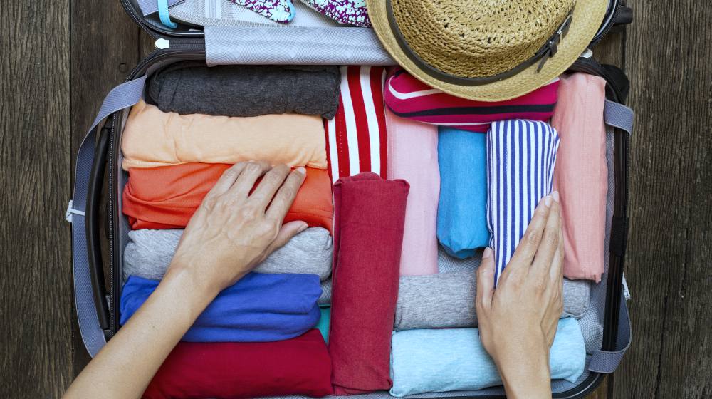 person packing luggage for trip | How To Reduce Travel Anxiety and Stress This Holiday Season | travel anxiety | travel anxiety symptoms