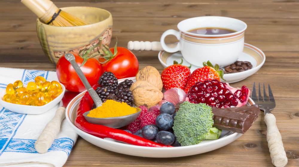 breakfast table with a plate filled with antioxidants fruits and vegetables | Hyperthyroidism Diet: Foods To Ease Symptoms | hyperthyroidism diet | hyperthyroidism symptoms
