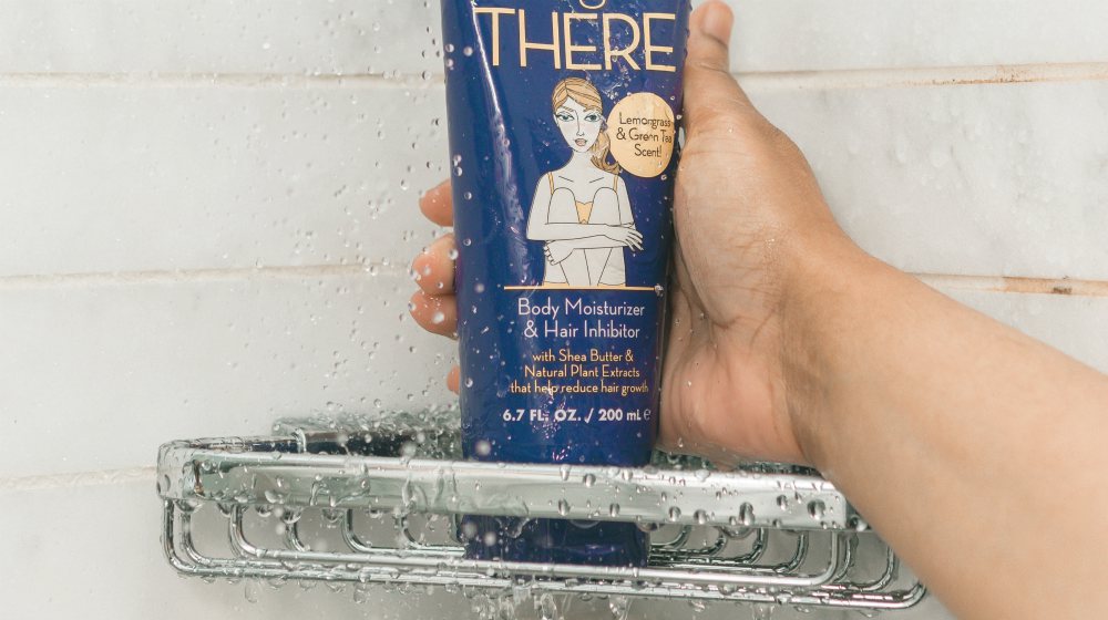 person holding body wash tube | Practical Anti-Aging Tips For Men | anti aging tips men | men skin care routine