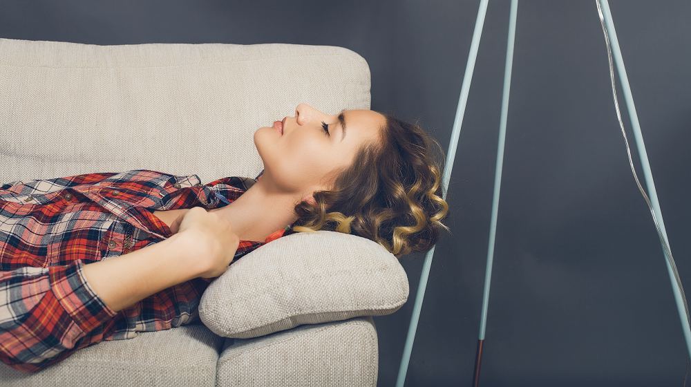 young woman sleeping on sofa | How To Balance Your Hormones Naturally | how to balance your hormones | natural ways to balance hormones