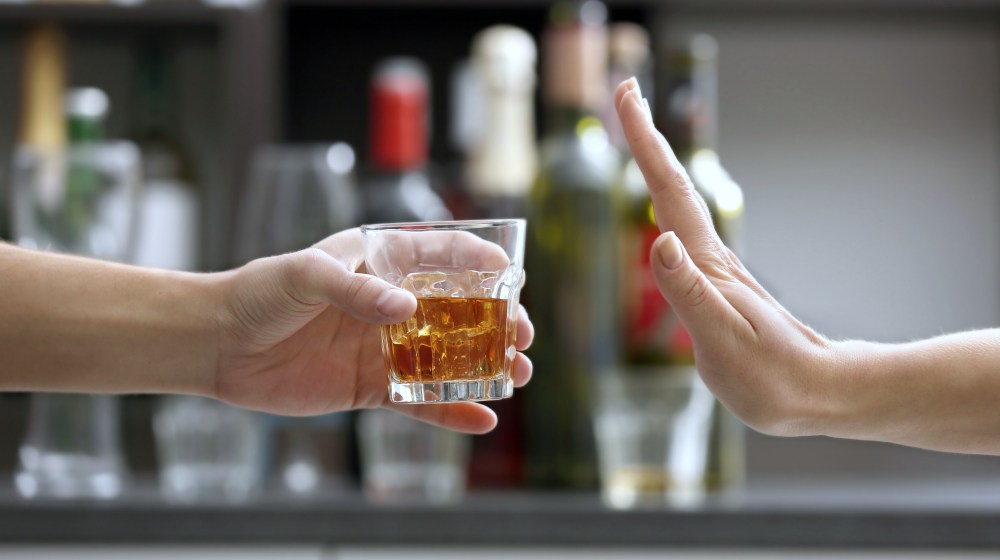 female hand refusing alcohol | Hashimoto Thyroiditis Treatment | Take Care Of Your Liver To Treat The Disease | hashimoto thyroiditis | hashimoto thyroiditis treatment