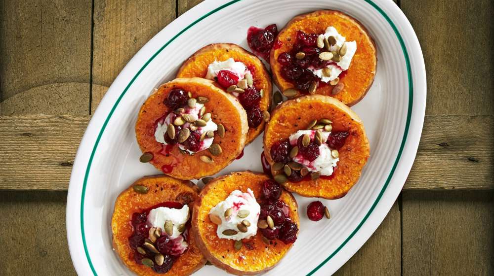 roasted squash with poached cranberries and goat cheese on a plate | Healthy Holiday Recipes For A Festive Dinner | healthy holiday recipes | holiday foods ideas