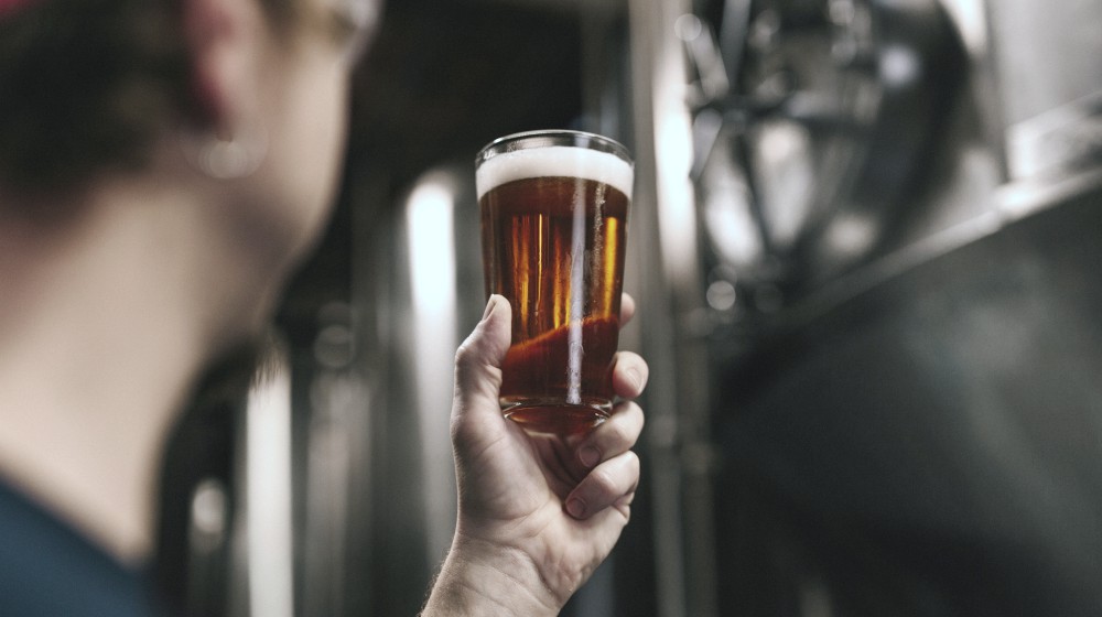 man holding a bottle of beer | Ways Sleep Deprivation Affects Your Sex Life | sleep deprivation and sex | sleep and testosterone