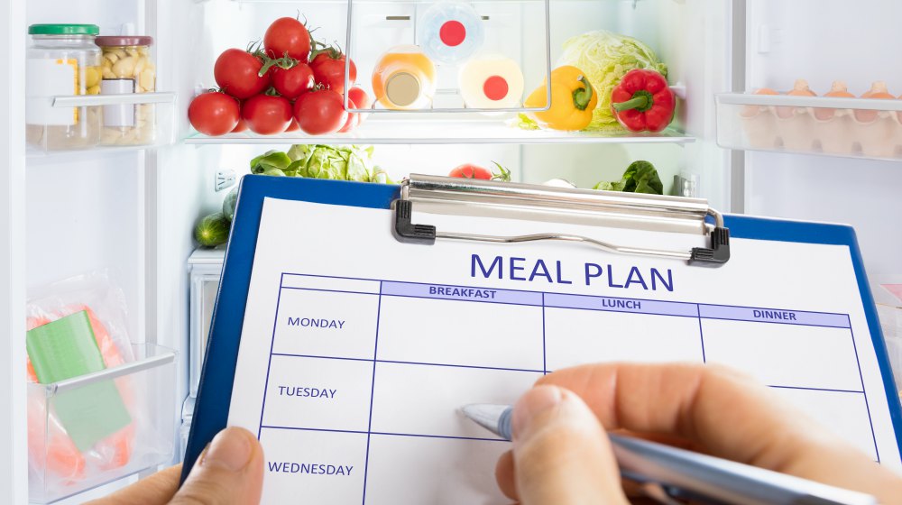 person writing a meal plan | How To Deal With Sleep Deprivation From Stress | how to deal with sleep deprivation | stress and insomnia