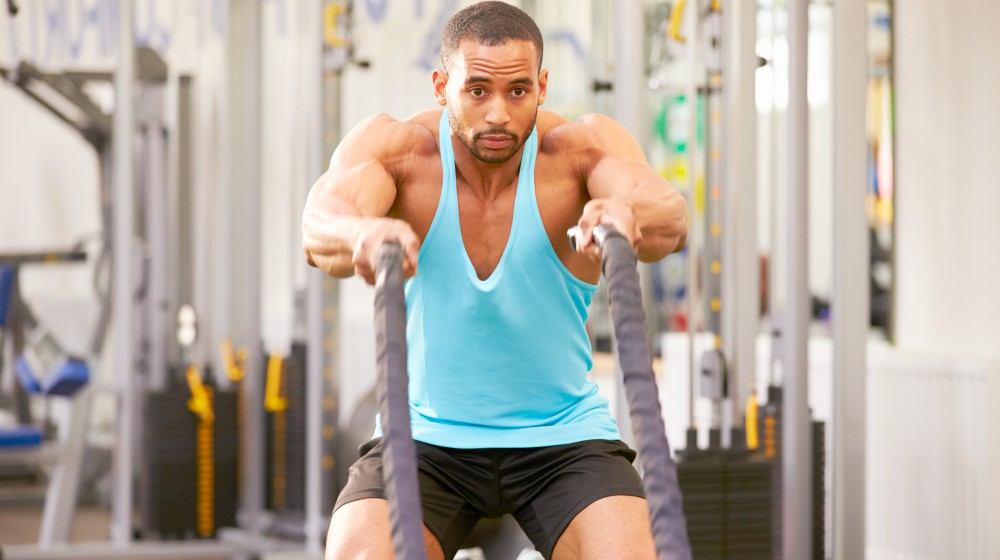 young man working out | How To Avoid Weight Gain This Holiday Season | how to not gain weight | average holiday weight gain