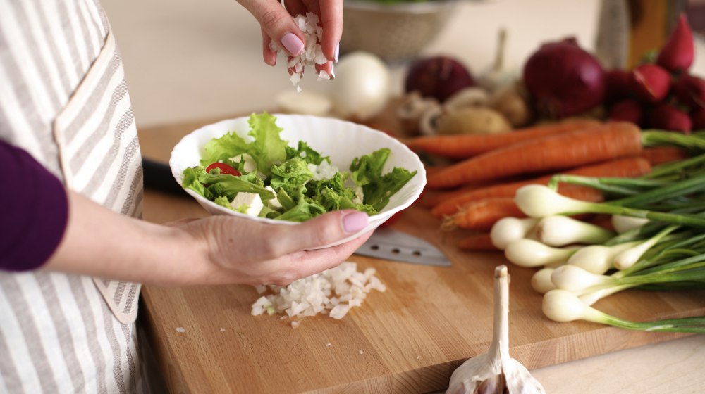 Young woman cooking in the kitchen | How To Do The Hormone Reset Diet Effectively | over 40 hormone reset diet