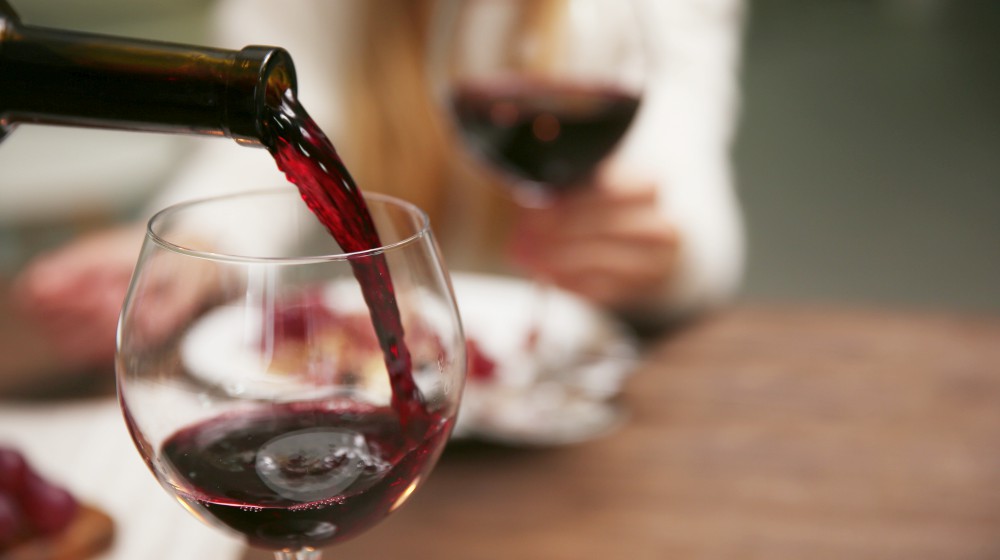 Pouring red wine from bottle into the wineglass | Low Thyroid Diet Recipes And Diet Tips | Hypothyroid Diet Plan | low thyroid diet | hypothyroidism diet plan