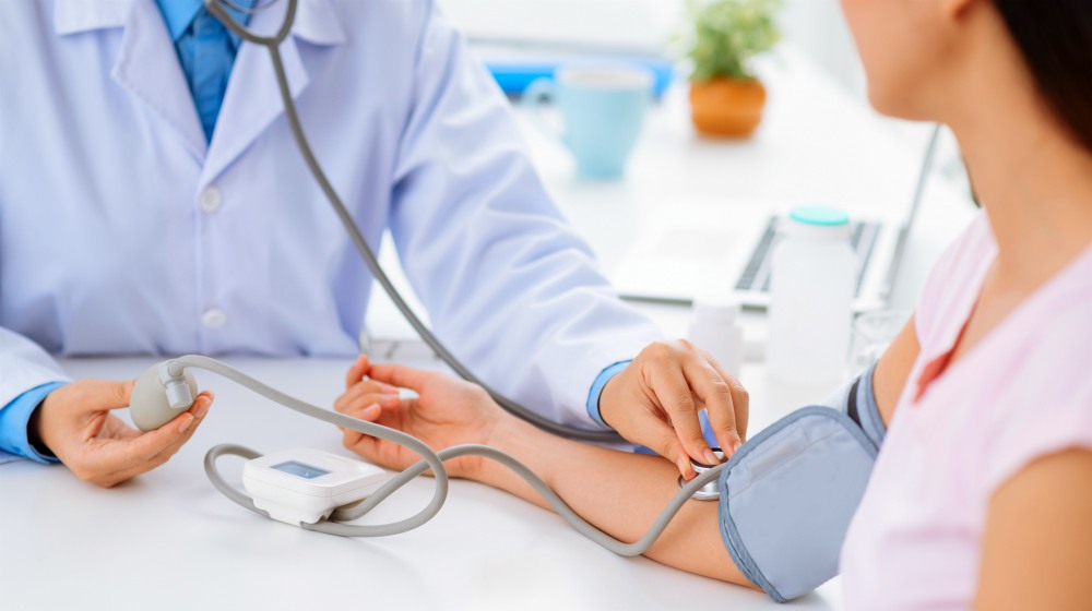 doctor checking the patient's blood pressure | Thyroid Pooling: Symptoms, Causes, and Treatments | thyroid pooling | stop the thyroid madness