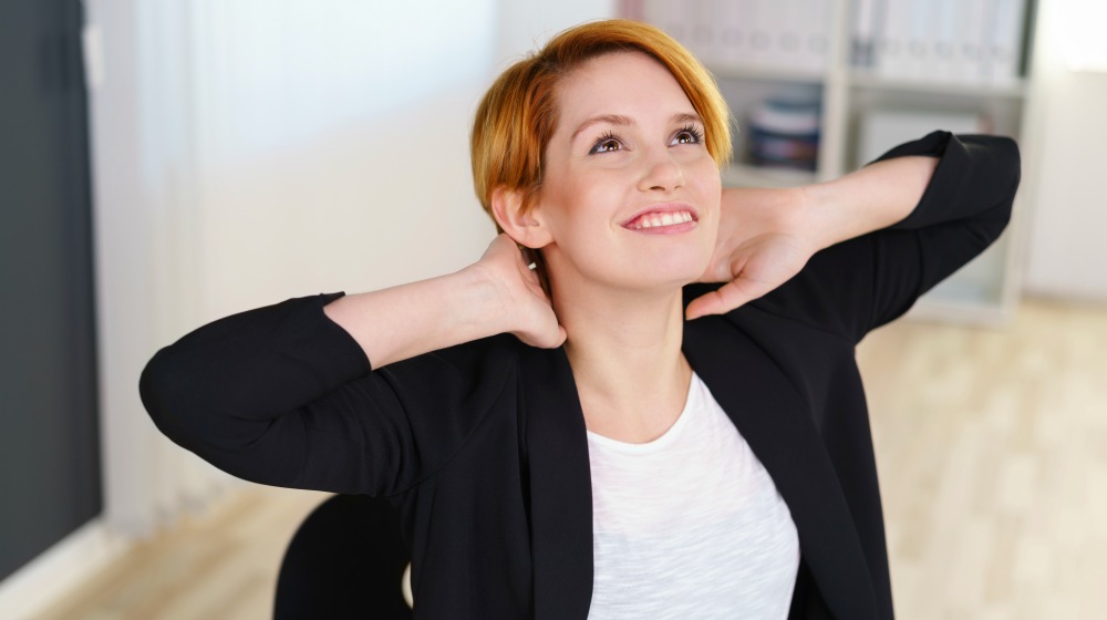 young businesswoman relaxing stretching her back with her hands behind her head | Thyroid Neck Check: A Step-By-Step Guide For Thyroid Disorders | thyroid neck check | hypothyroidism symptoms