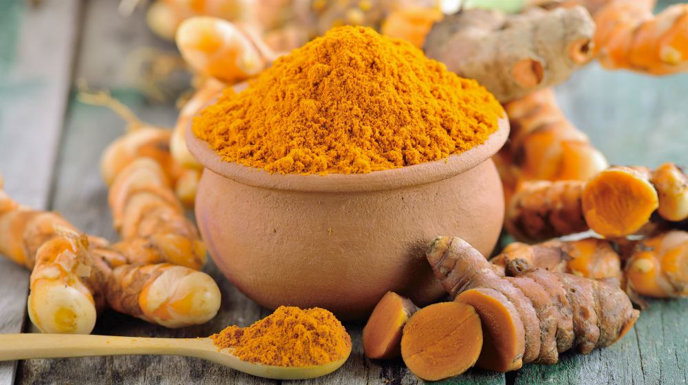 turmeric roots basket on wooden table | Low Thyroid Diet Recipes And Diet Tips | Hypothyroid Diet Plan | low thyroid diet | hypothyroidism diet plan