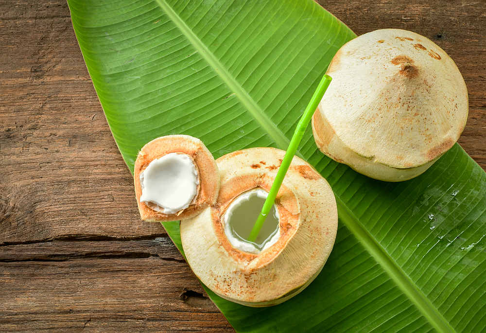 Young coconut fruit cut open to drink sweet juice and eat | Best Testosterone Boosters To Add To Your Diet | foods that boost testosterone