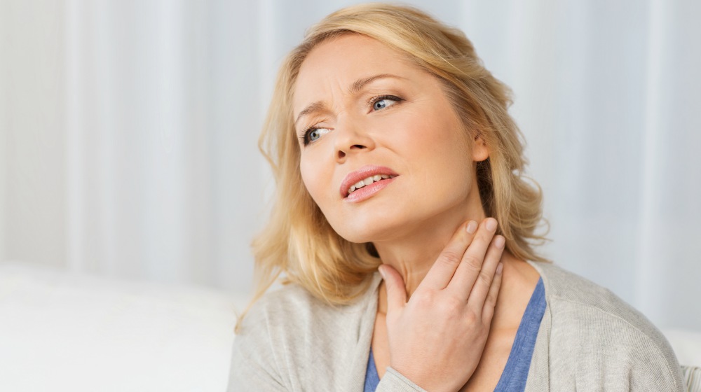 woman suffering from throat pain | Thyroid Neck Check: A Step-By-Step Guide For Thyroid Disorders | thyroid neck check | enlarged thyroid