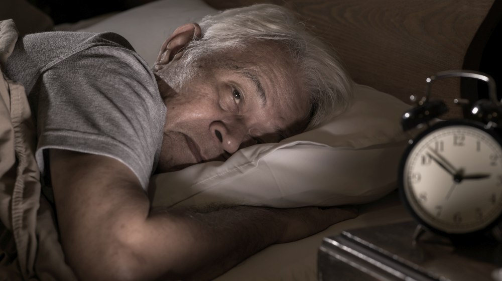 depressed senior man lying in bed cannot sleep from insomnia | The Link Between Dementia and Sleep: Factors | dementia and sleep | dementia brain