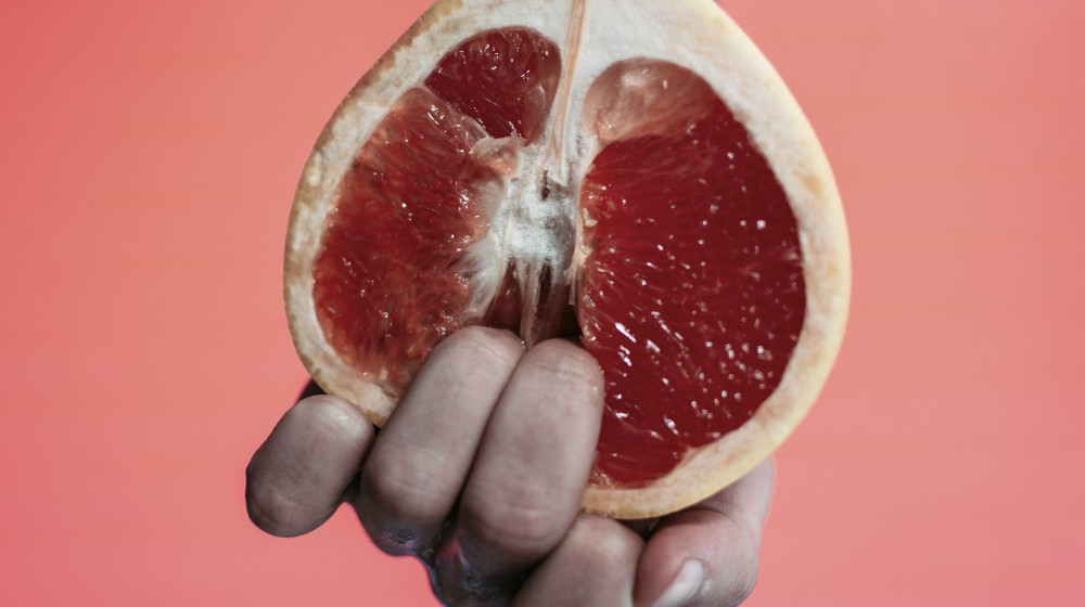 person holding sliced fruit | How Does A Normal Vagina Change With Age? | normal vagina | good vaginal health